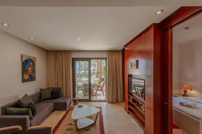 a living room with a couch and a table at Classy 1-Bedroom Apartment in Ancient Sands with Pool View in Hurghada
