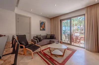 a living room with a couch and a table at Classy 1-Bedroom Apartment in Ancient Sands with Pool View in Hurghada