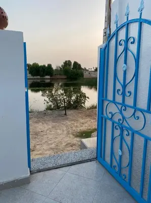 an open door with a view of a body of water at Villa Victoria Old Nile View in Luxor