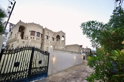a white house with a fence at Villa Nur in Luxor