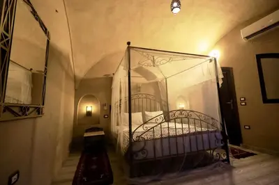 a bedroom with a metal bed in a room at Villa Nur in Luxor