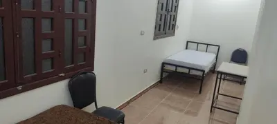 a room with two chairs and a table and a door at Luxor in Luxor