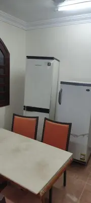a room with a table and chairs and a refrigerator at Luxor in Luxor