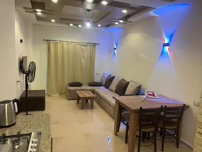 a living room with a couch and a table at MARINA SKY in Hurghada
