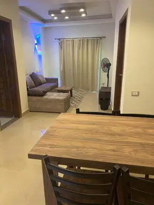 a living room with a table and a couch at MARINA SKY in Hurghada