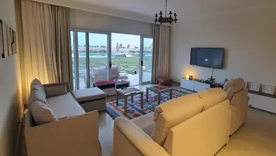 a living room with two couches and a television at Soma Bay Ambiance - Relaxed Apartment - Next to The Breakers in Hurghada