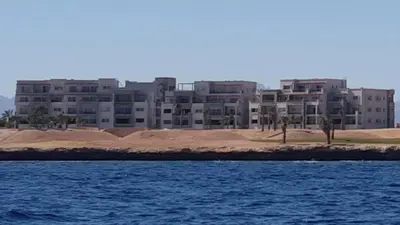 a large apartment building on the shore of a body of water at Soma Bay Ambiance - Relaxed Apartment - Next to The Breakers in Hurghada