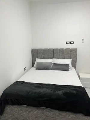 a bedroom with a large bed with a black blanket at Boka Bay One in Hurghada