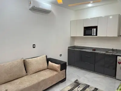 a living room with a couch and a kitchen at Boka Bay One in Hurghada