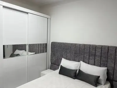 a bedroom with a bed with two pillows and a mirror at Boka Bay One in Hurghada