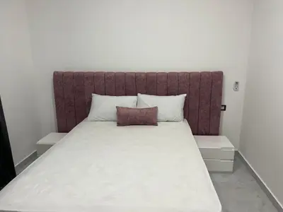 a large bed with a brown headboard in a room at Boka Bay One in Hurghada