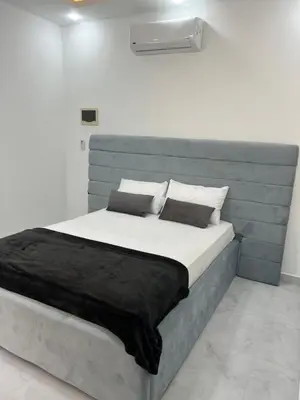 a bedroom with a large bed with a blue headboard at Boka Bay One in Hurghada