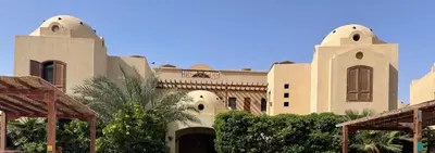 a large building with trees in front of it at Sabina 1br apartment Lagoon view with shared pool By BFG Beit Fel Gouna in Hurghada