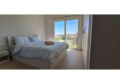 a bedroom with a bed with a teddy bear on it at El Gouna Waterside, 2-Bd Ground Floor Sleeps 4 Persons in El Gouna