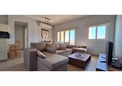 a living room with a couch and a tv at El Gouna Waterside, 2-Bd Ground Floor Sleeps 4 Persons in El Gouna