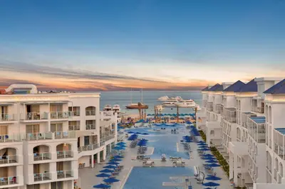 a view of a resort with a pool and the ocean at Pickalbatros Blu Spa Resort - Adults Friendly 16 Years Plus- Ultra All-Inclusive in Hurghada