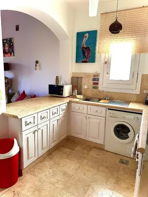 a kitchen with a sink and a washing machine at South Marina Apartment Wi-Fi available in Hurghada