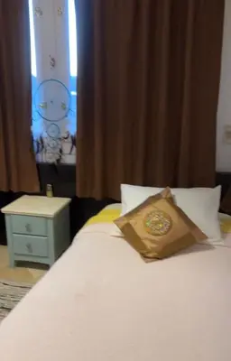 a bed with a bag sitting on top of it at South Marina Apartment Wi-Fi available in Hurghada
