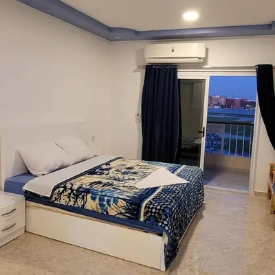 a bedroom with a bed and a window at Blue Nile House in Luxor
