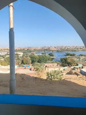 a view from a window of a beach and water at Nukud guest house in Aswan