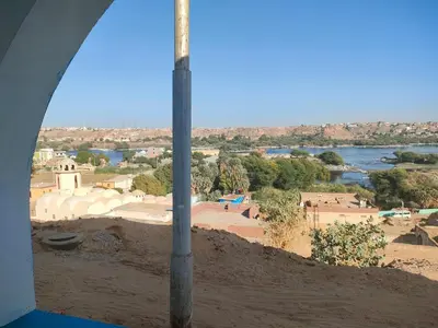 a view of a city and a river from a window at Nukud guest house in Aswan