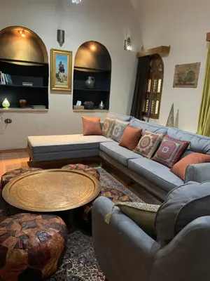 a living room with a couch and a table at The Residence in Luxor