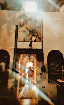 a person walking through a room with a painting at The Residence in Luxor