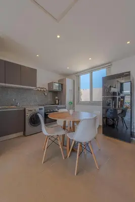 a kitchen with a table and chairs in a kitchen at Lovely 1 Bedroom with private heated Jacuzzi at Sholan El Gouna in Hurghada