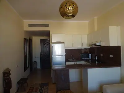 a kitchen with white cabinets and a counter top at Florenza - sea view in Hurghada