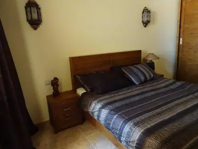 a bedroom with a bed and a night stand and lights at Florenza - sea view in Hurghada