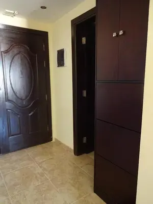 a room with a wooden door and a cabinet at Florenza - sea view in Hurghada