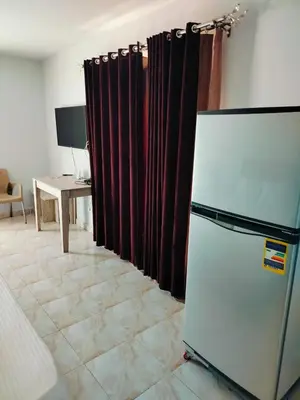 a kitchen with a refrigerator and a table and a desk at Fully furnished Studio, At Tiba View, NUMBER R75 in Hurghada