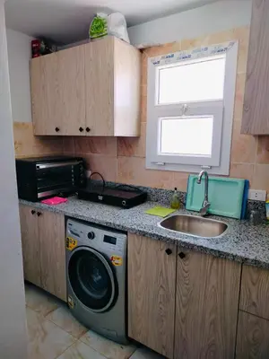 a kitchen with a sink and a washing machine at Fully furnished Studio, At Tiba View, NUMBER R75 in Hurghada