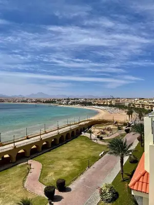 a bridge over a beach next to a body of water at Apartman Andalusie in Hurghada