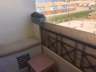 a balcony with a bench and a view of a street at Apartman Andalusie in Hurghada