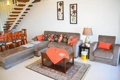 a living room with a couch and chairs and a table at Prime Home The View Hurghada in Hurghada