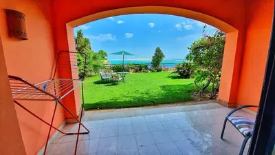 an open door to a patio with a view of a yard at Prime Home The View Hurghada in Hurghada