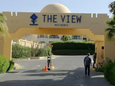 a man is standing in front of a building at Prime Home The View Hurghada in Hurghada