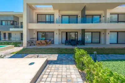 a large house with a patio in front of it at Cozy 2-Bedroom Apartment in G-Cribs, El Gouna. Terrace & Pool in Hurghada