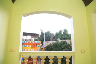 a window in a room with bottles on a shelf at Nubian Dreams Guest House in Aswan