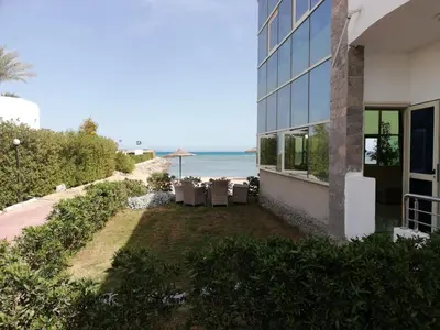 a building with a yard next to the beach at Cecelia in Hurghada