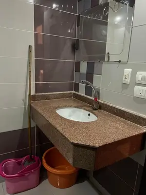 a bathroom counter with a sink and a mirror at Cecelia in Hurghada