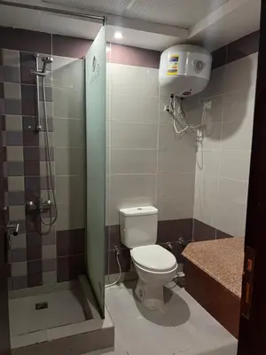 a bathroom with a toilet and a shower stall at Cecelia in Hurghada