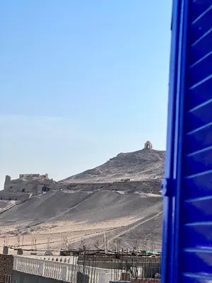a view of a hill from a bus at Ghalia Guest House in Aswan