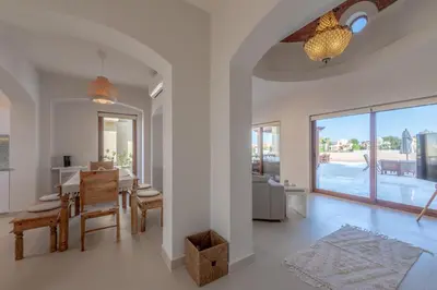 a dining room and living room with a dining table at Fresh Breeze High-End 2BR Villa with Private Pool, Sabina, El Gouna in Hurghada