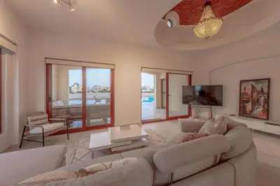 a living room with a couch and a tv at Fresh Breeze High-End 2BR Villa with Private Pool, Sabina, El Gouna in Hurghada