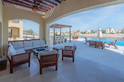 a living room with a couch and chairs and a pool at Fresh Breeze High-End 2BR Villa with Private Pool, Sabina, El Gouna in Hurghada