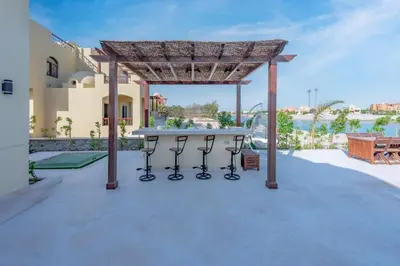 a patio with a table and a pergola at Fresh Breeze High-End 2BR Villa with Private Pool, Sabina, El Gouna in Hurghada