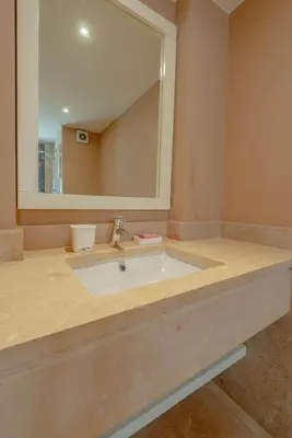 a bathroom with a sink and a large mirror at 3BR Family Villa in Sabina, El Gouna. Lagoon & Private Pool in Hurghada