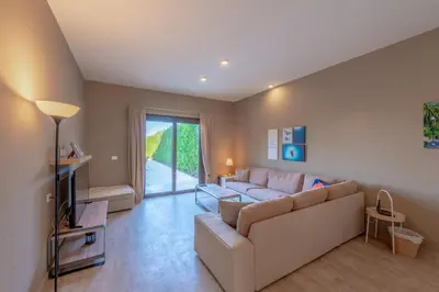a living room with a couch and a tv at 3BR Family Villa in Sabina, El Gouna. Lagoon & Private Pool in Hurghada